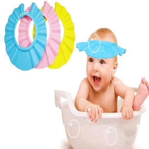 Happy baby wearing an eco-friendly baby shower hat in blue, surrounded by bubbles during bath time.