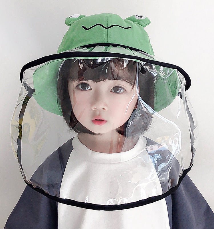 Child wearing an anti-spitting fisherman hat with a clear protective shield and frog design for outdoor safety