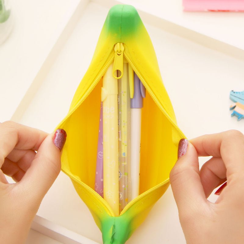 Colorful silicone banana storage bag with pens inside, featuring a fun novelty design.