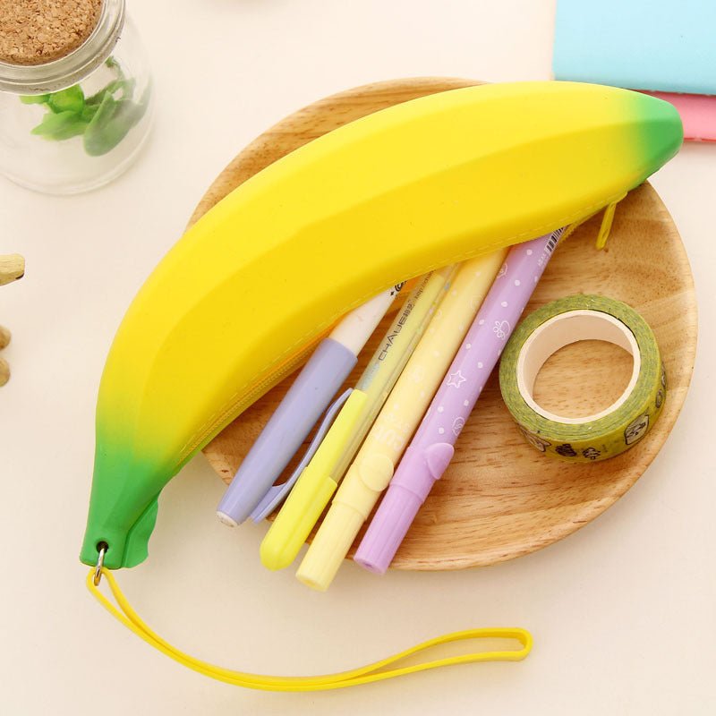 Colorful silicone banana storage bag with pens and tape inside, perfect for school supplies