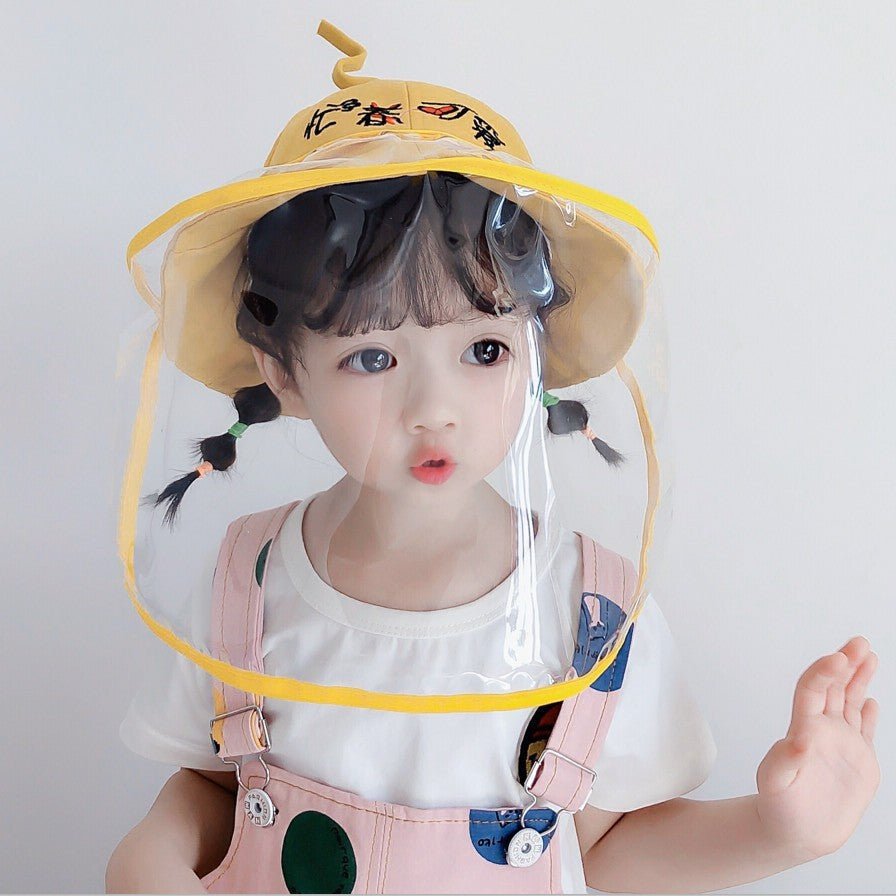 Child wearing a yellow anti-spitting fisherman hat with a clear face shield, perfect for outdoor protection