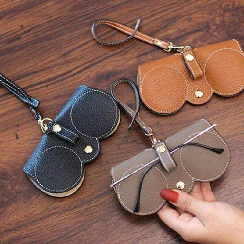 Trendy fashion sunglasses case collection featuring black, brown, and gray designs with snap closures and wrist straps.