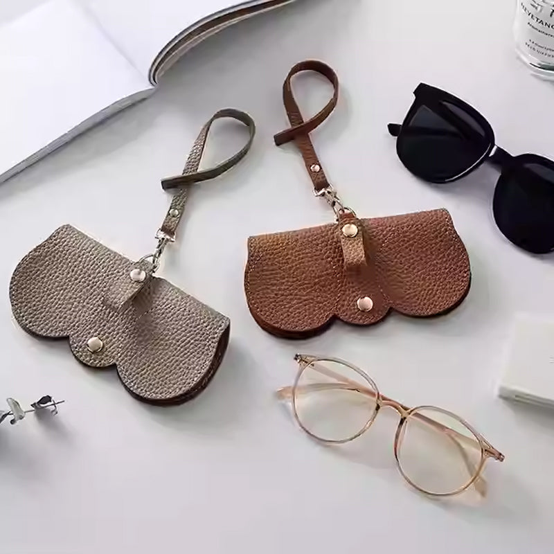 Fashion sunglasses case in beige and brown leather, stylish design perfect for protecting eyewear.