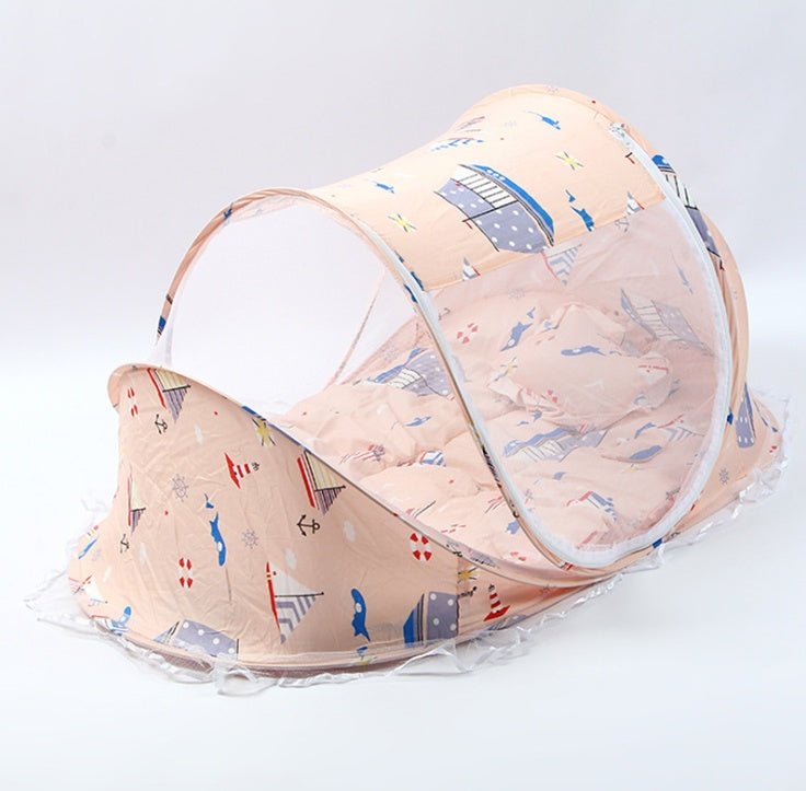 Foldable baby bed net with pillow in soft fabric featuring colorful whale patterns, ideal for safe sleep and travel